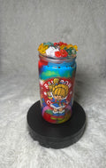 A colorful rainbow-themed jar filled with layered rainbow-colored material and topped with small multicolored flower-like decorations, displayed on a black round base against a soft gray background.